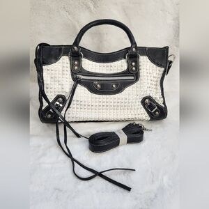 Black and white handbag with tassels